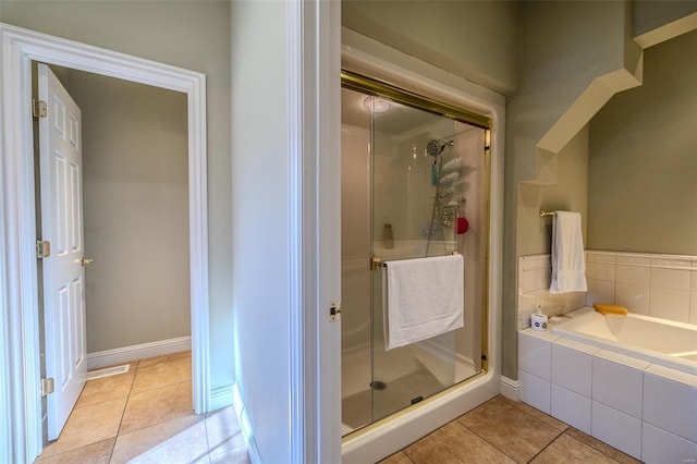 bathroom featuring tile patterned floors and separate shower and tub