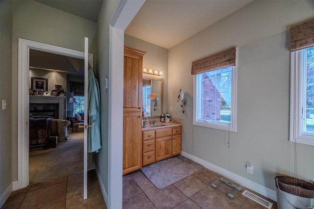 bathroom featuring tile patterned flooring, vanity, and a wealth of natural light