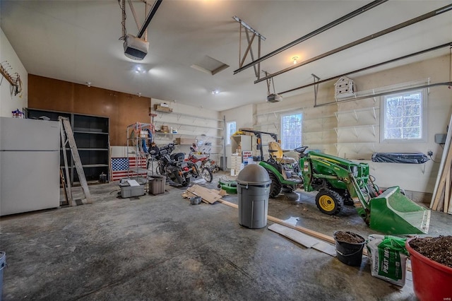 garage with a garage door opener and white refrigerator