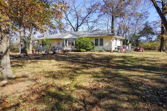 back of property featuring a lawn