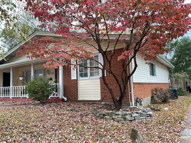 view of front of home with covered porch and central AC unit