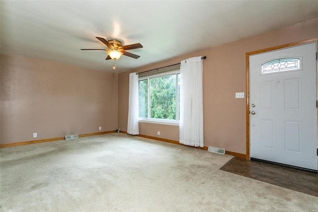 foyer with light carpet and ceiling fan