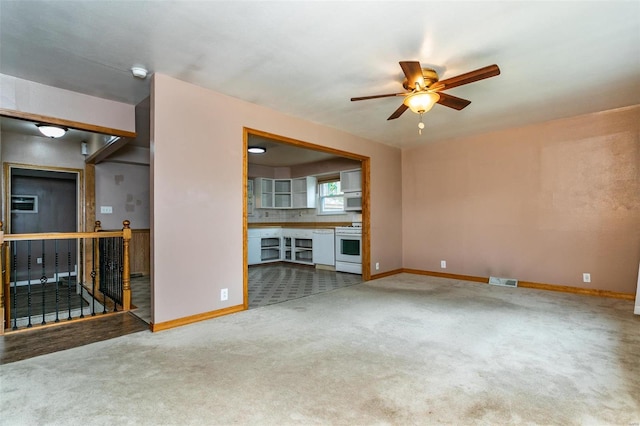 unfurnished living room with ceiling fan and carpet floors