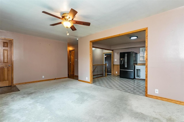 unfurnished living room featuring carpet floors and ceiling fan