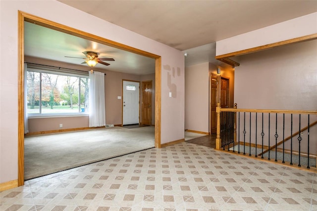 carpeted empty room featuring ceiling fan