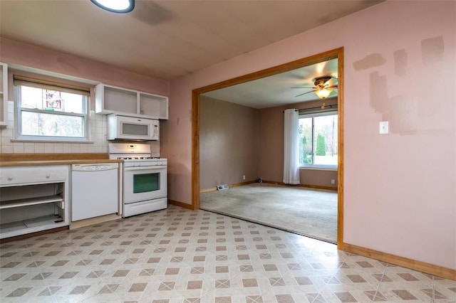 kitchen with white appliances, white cabinetry, plenty of natural light, and ceiling fan