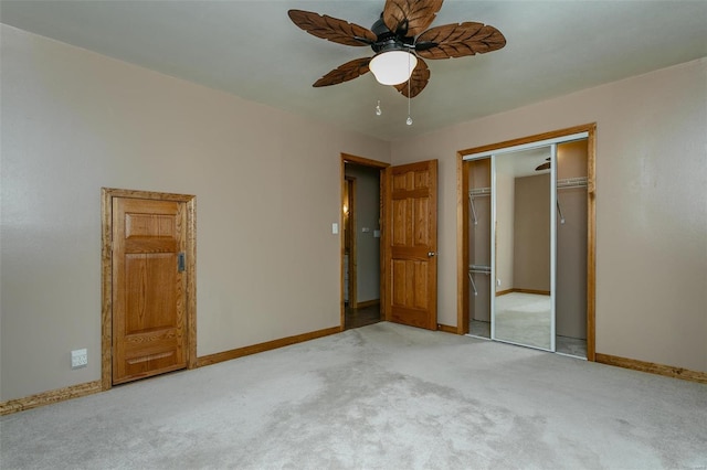 unfurnished bedroom featuring a closet, light colored carpet, and ceiling fan