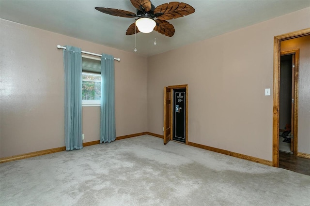 unfurnished room featuring ceiling fan and light carpet