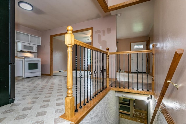 staircase featuring ceiling fan