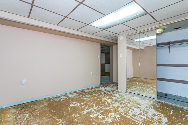 basement featuring a paneled ceiling