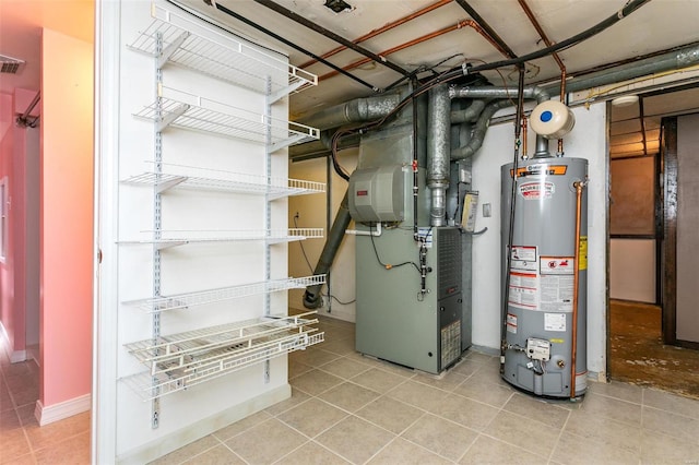 utility room with heating unit and water heater