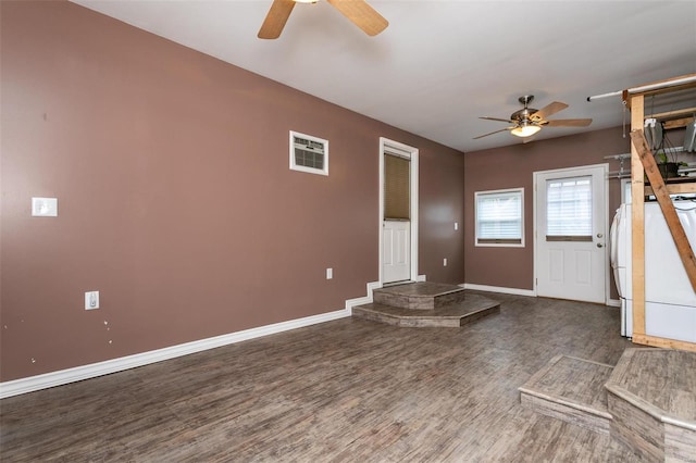 foyer featuring ceiling fan and dark wood-type flooring