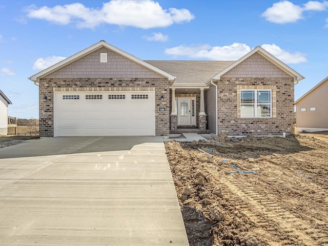 single story home featuring brick siding, driveway, and a garage