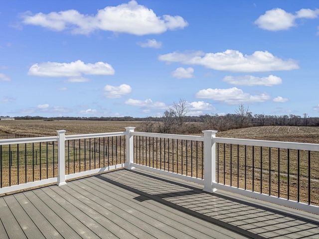 wooden deck with a rural view