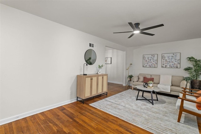 living room featuring dark hardwood / wood-style flooring and ceiling fan