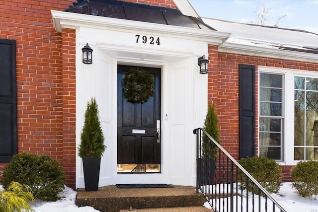 view of snow covered property entrance