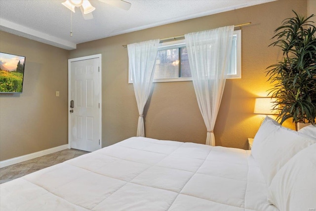 bedroom with a textured ceiling and ceiling fan