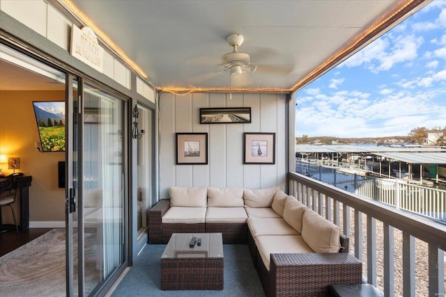 balcony with an outdoor living space and a water view