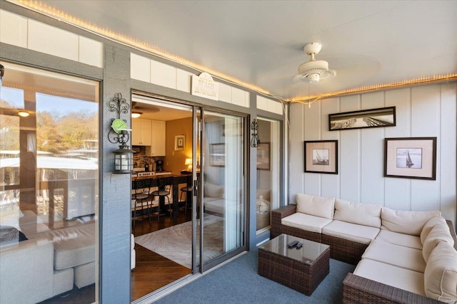 living room with hardwood / wood-style flooring and ceiling fan