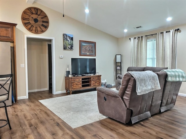 living room with wood-type flooring and lofted ceiling