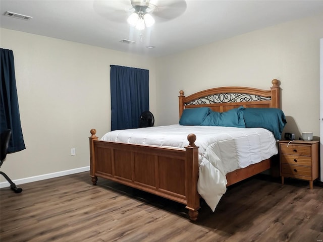 bedroom with ceiling fan and dark wood-type flooring