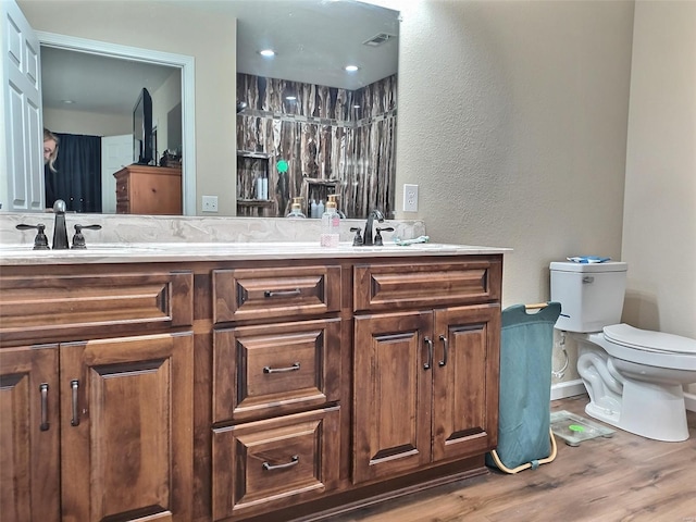 bathroom featuring hardwood / wood-style flooring, vanity, and toilet