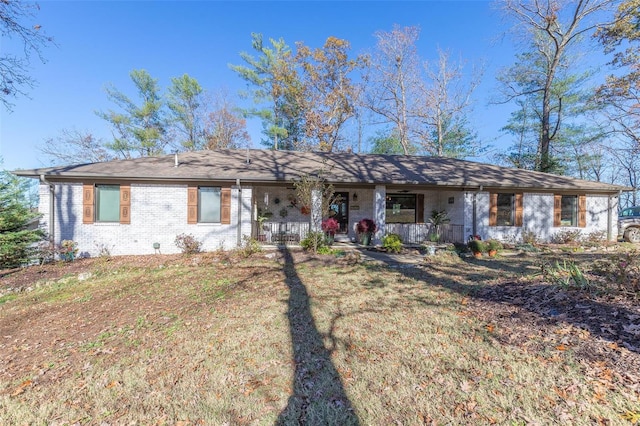 single story home featuring a front lawn and covered porch