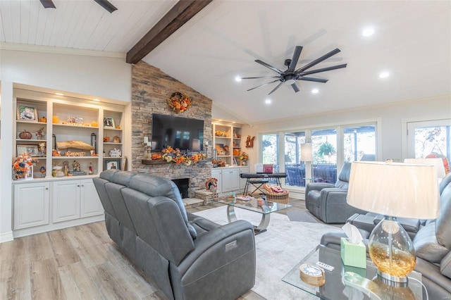 living room featuring a stone fireplace, ceiling fan, light hardwood / wood-style flooring, and lofted ceiling with beams