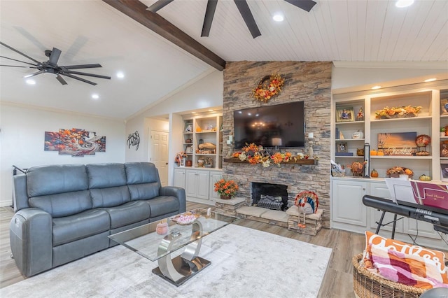 living room with beam ceiling, ceiling fan, a stone fireplace, high vaulted ceiling, and light wood-type flooring