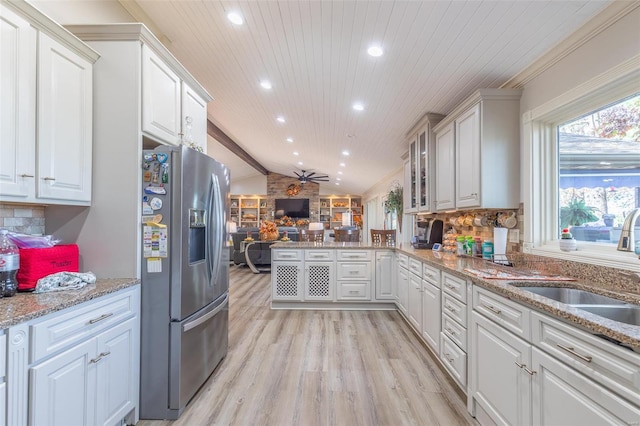 kitchen featuring stainless steel refrigerator with ice dispenser, light wood-type flooring, wood ceiling, vaulted ceiling, and white cabinets