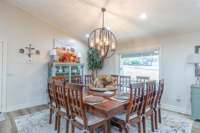 dining area with ornamental molding, hardwood / wood-style floors, lofted ceiling, wooden ceiling, and a notable chandelier