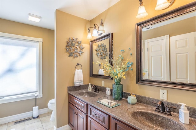 bathroom featuring tile patterned flooring, vanity, and toilet