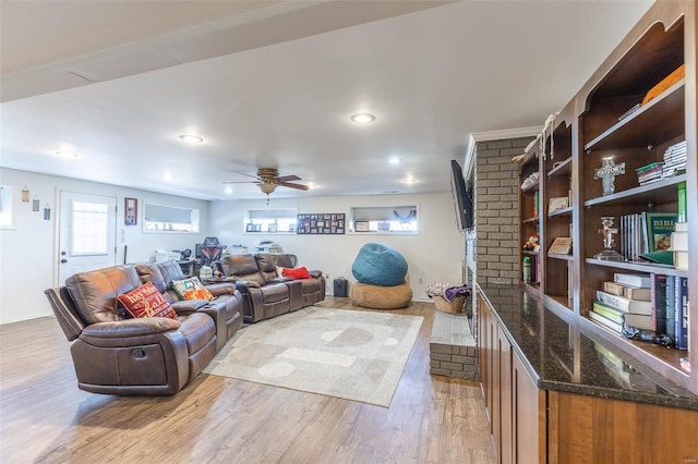 living room with light hardwood / wood-style flooring and ceiling fan