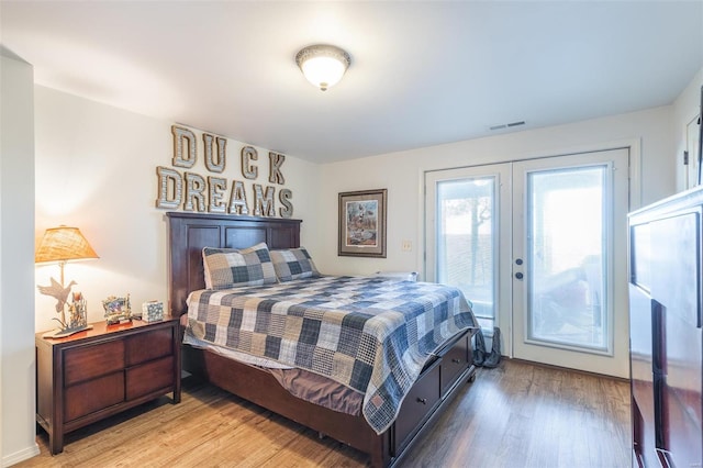 bedroom with access to outside, french doors, and light hardwood / wood-style floors