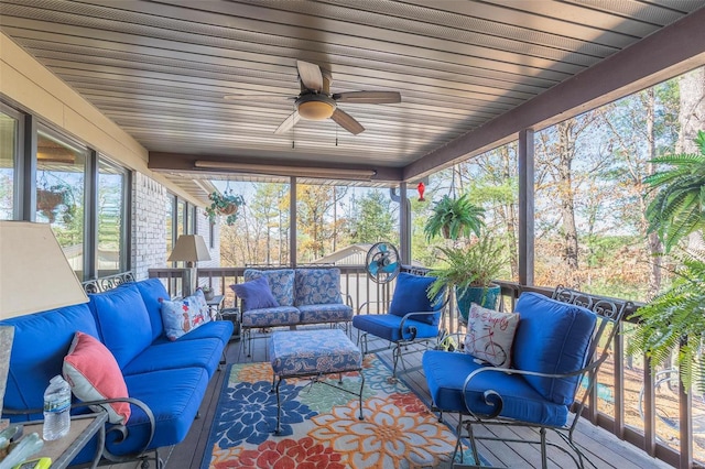 sunroom featuring ceiling fan