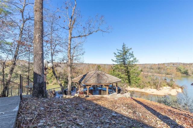 view of yard featuring a gazebo and a water view