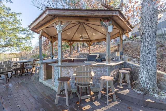 wooden deck featuring a gazebo, area for grilling, and a bar