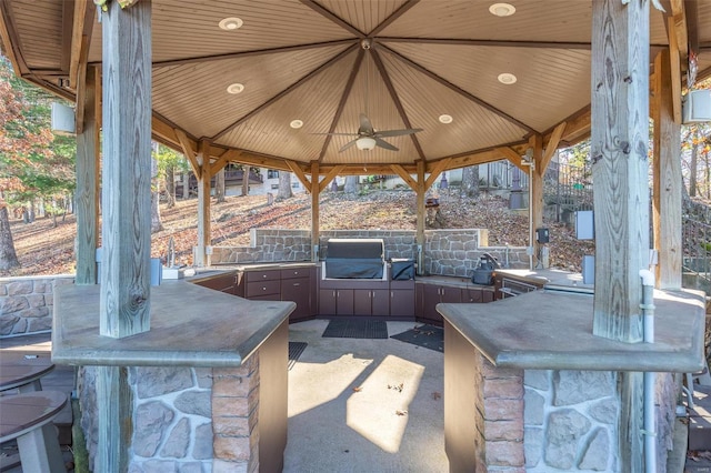 view of patio / terrace featuring a gazebo, area for grilling, a wet bar, and ceiling fan