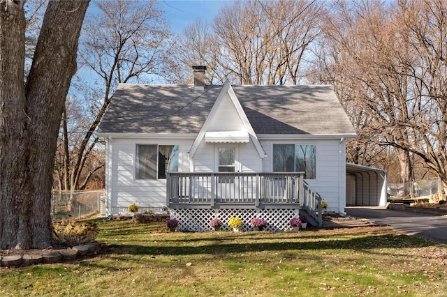 view of front of house featuring a carport, a wooden deck, and a front lawn