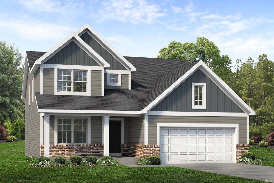 view of front of house featuring a garage and a front lawn