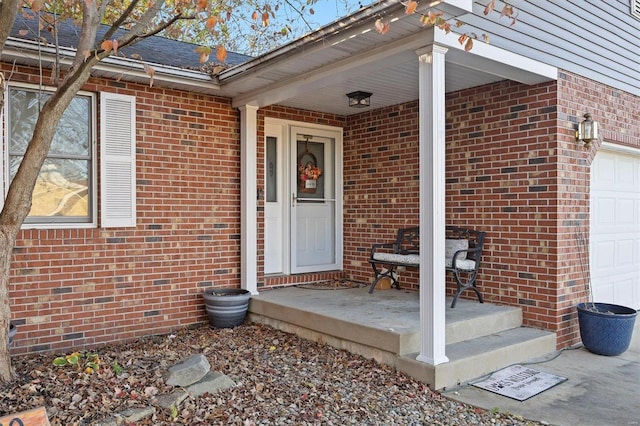 property entrance featuring covered porch and a garage