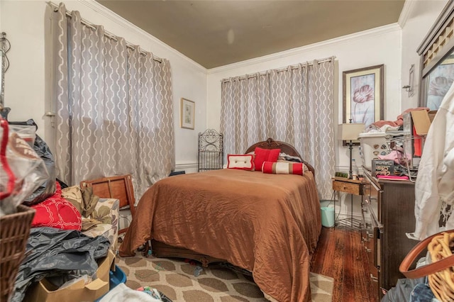 bedroom with dark hardwood / wood-style flooring and ornamental molding