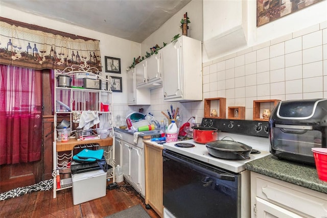 kitchen with white cabinets, white electric range oven, dark hardwood / wood-style floors, and decorative backsplash