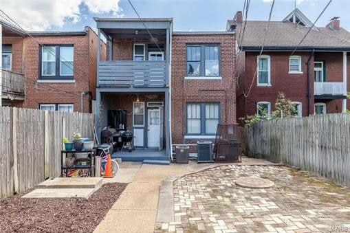 back of house featuring a patio and a balcony