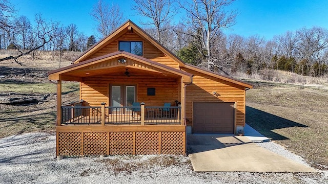 view of front of house featuring ceiling fan, french doors, a wooden deck, and a garage