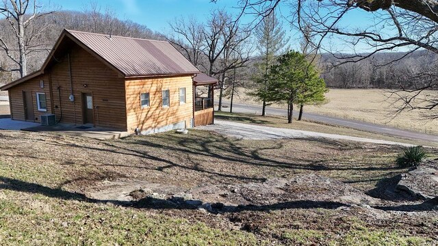 view of home's exterior featuring central AC unit and metal roof