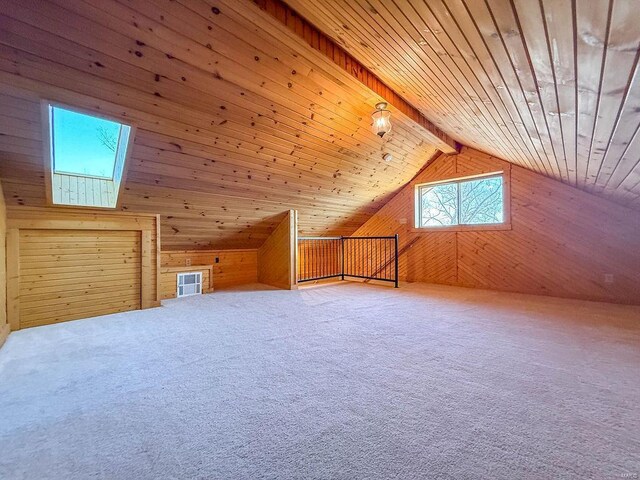 bonus room featuring wooden ceiling, vaulted ceiling with skylight, wood walls, and carpet floors