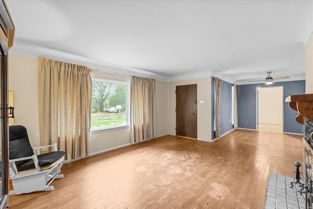 living room featuring hardwood / wood-style flooring and ceiling fan