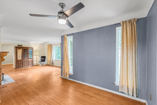 unfurnished living room featuring ceiling fan and light hardwood / wood-style flooring