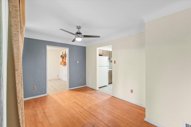 spare room featuring ceiling fan and light wood-type flooring